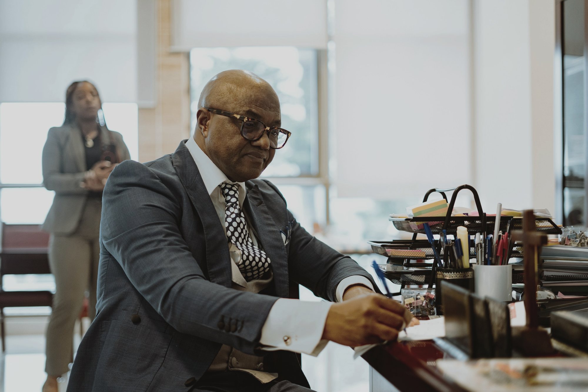 A lawyer reading a file at his desk