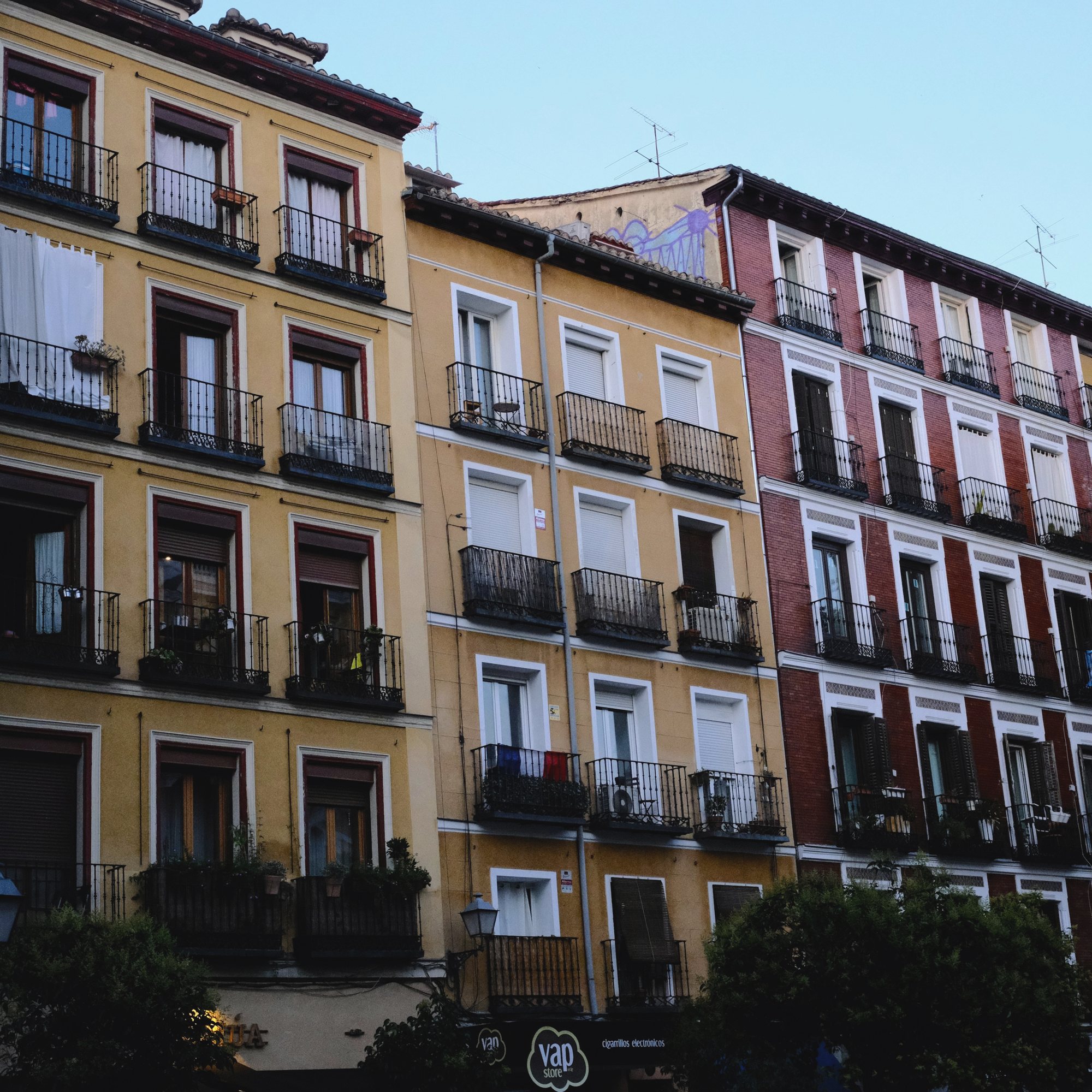 Fachada amarilla con balcones de forja